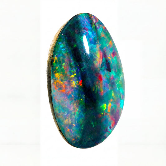 A polished oval opal gemstone displaying a vibrant play-of-colour with flashes of blue, green, yellow, orange, and red on a dark base, isolated on a solid white background.