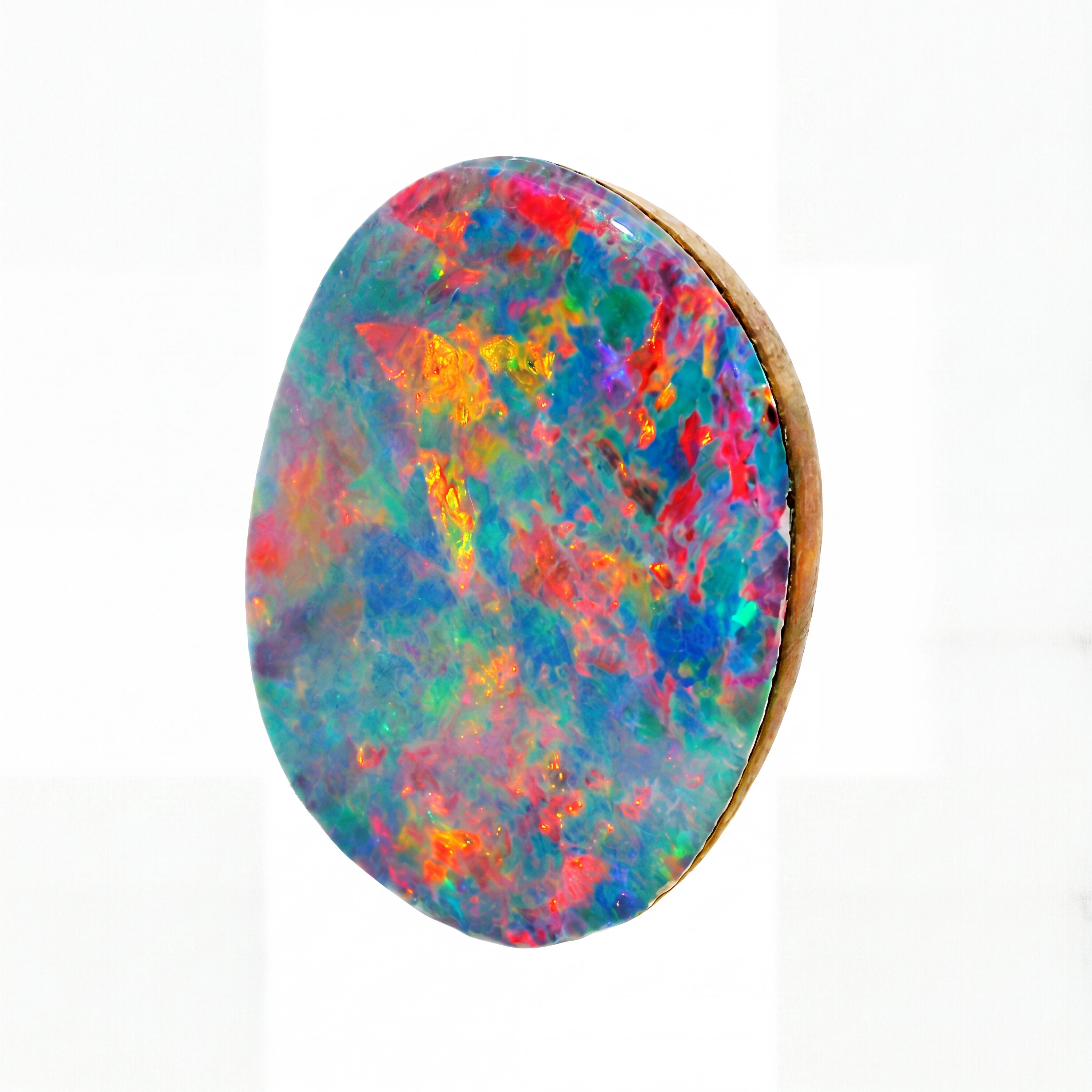A round cabochon gemstone featuring a vibrant, multicoloured play-of-colour pattern with blue, green, pink, orange, and purple hues, set in a gold-toned bezel against a white background.