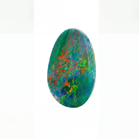 A polished oval cabochon gemstone featuring a vibrant play-of-colour pattern with green, blue, orange, and purple hues, set against a plain white background.