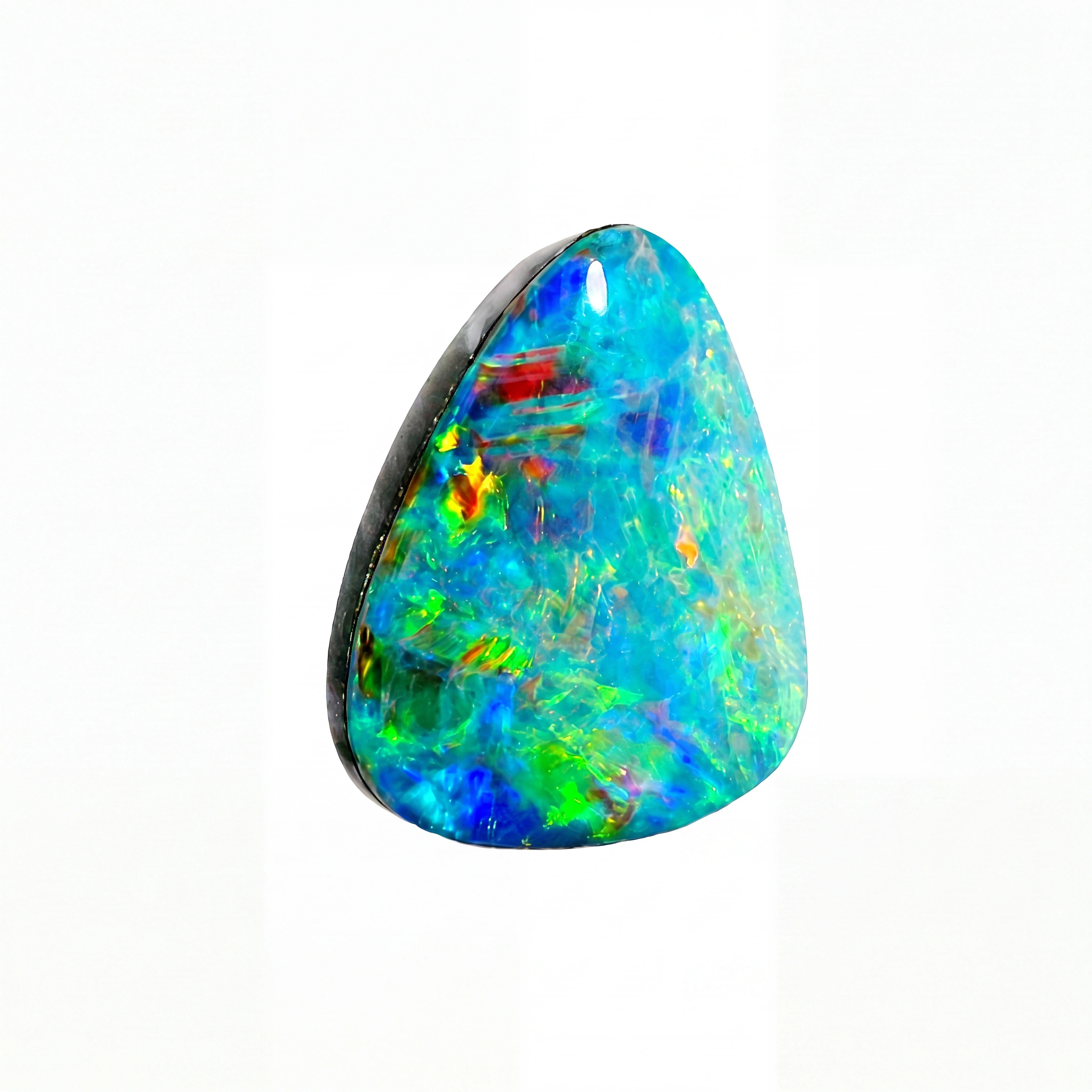 A triangular cabochon opal gemstone displaying vibrant iridescent colours including blue, green, orange, and red, set against a solid white background.