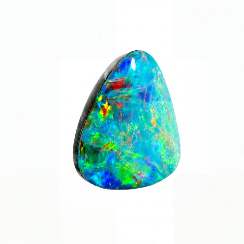 A triangular cabochon opal gemstone displaying vibrant iridescent colours including blue, green, orange, and red, set against a solid white background.