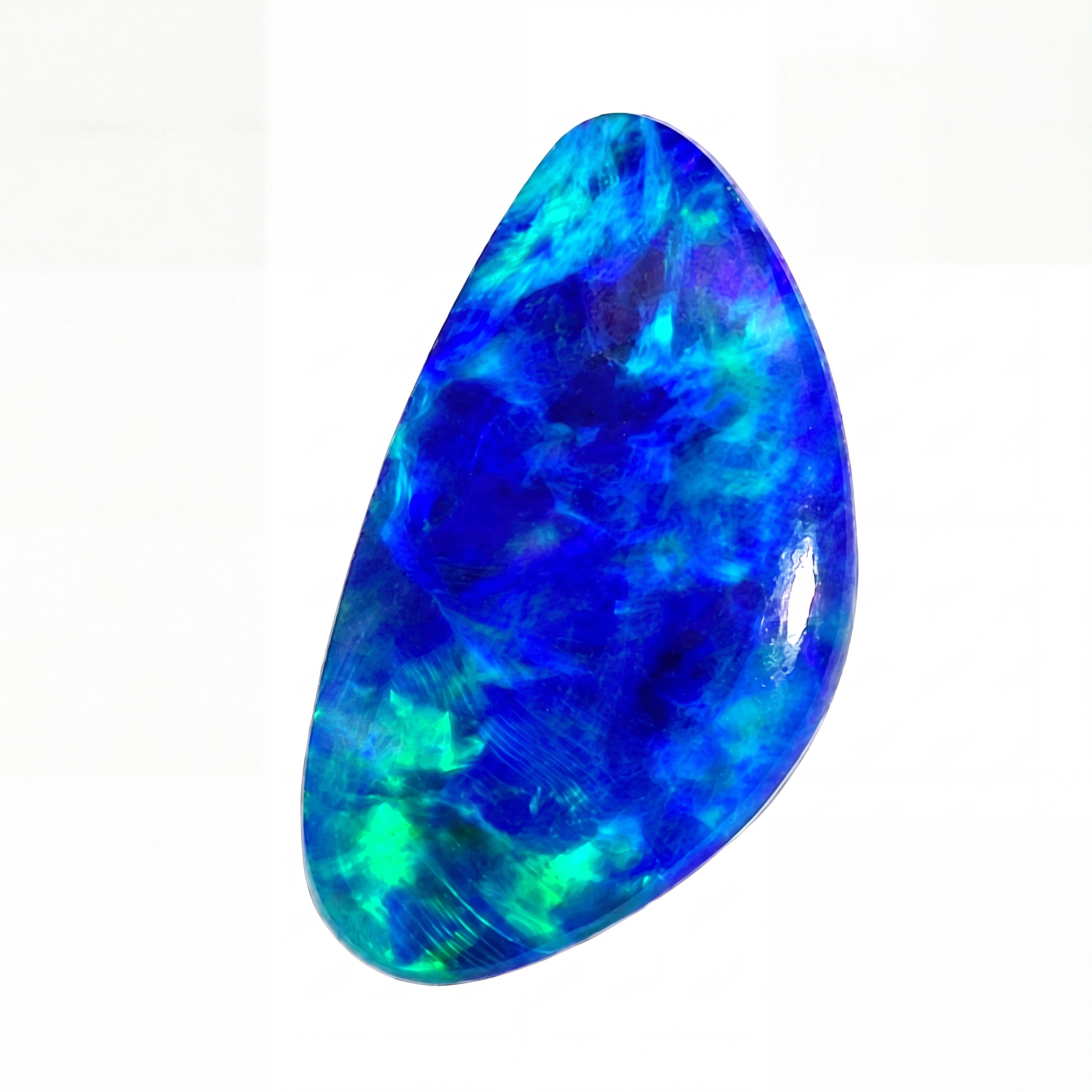 A polished teardrop-shaped cabochon gemstone with vibrant blue and green opalescent play-of-colour, shown on a plain white background.