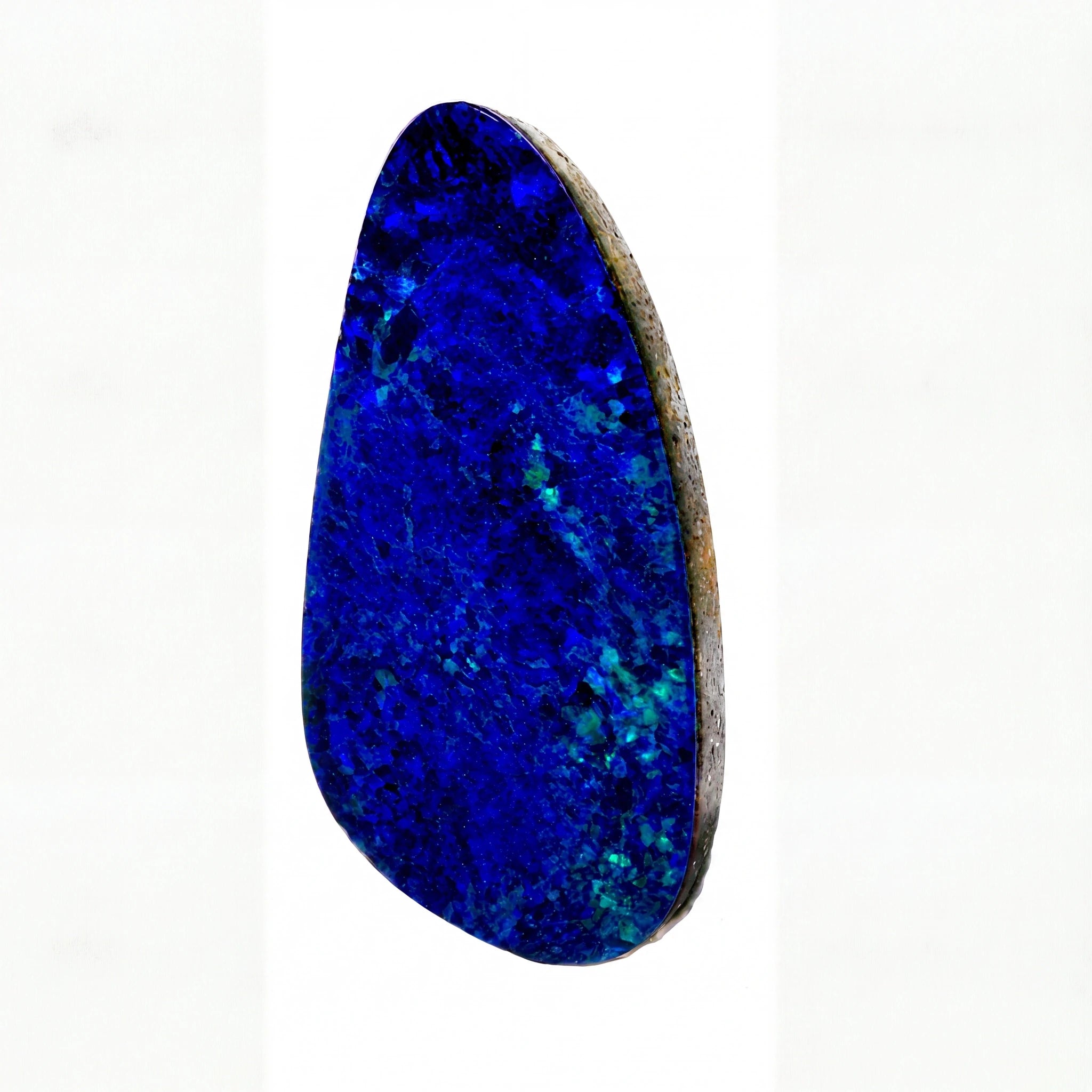 A polished natural opal stone cabochon with vibrant deep blue and teal matrix, set in a raw brownish-grey border, shown on a plain white background.