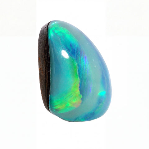 A polished cabochon opal gemstone with a teardrop shape, displaying a mix of blue, green, yellow, and orange iridescent colours against a white background.