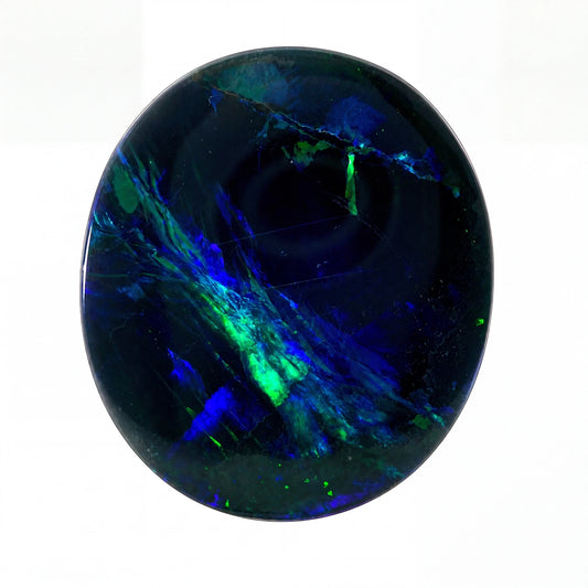 A polished oval cabochon gemstone featuring a deep black base with vibrant, swirling patterns of electric blue and neon green, set against a plain white background.