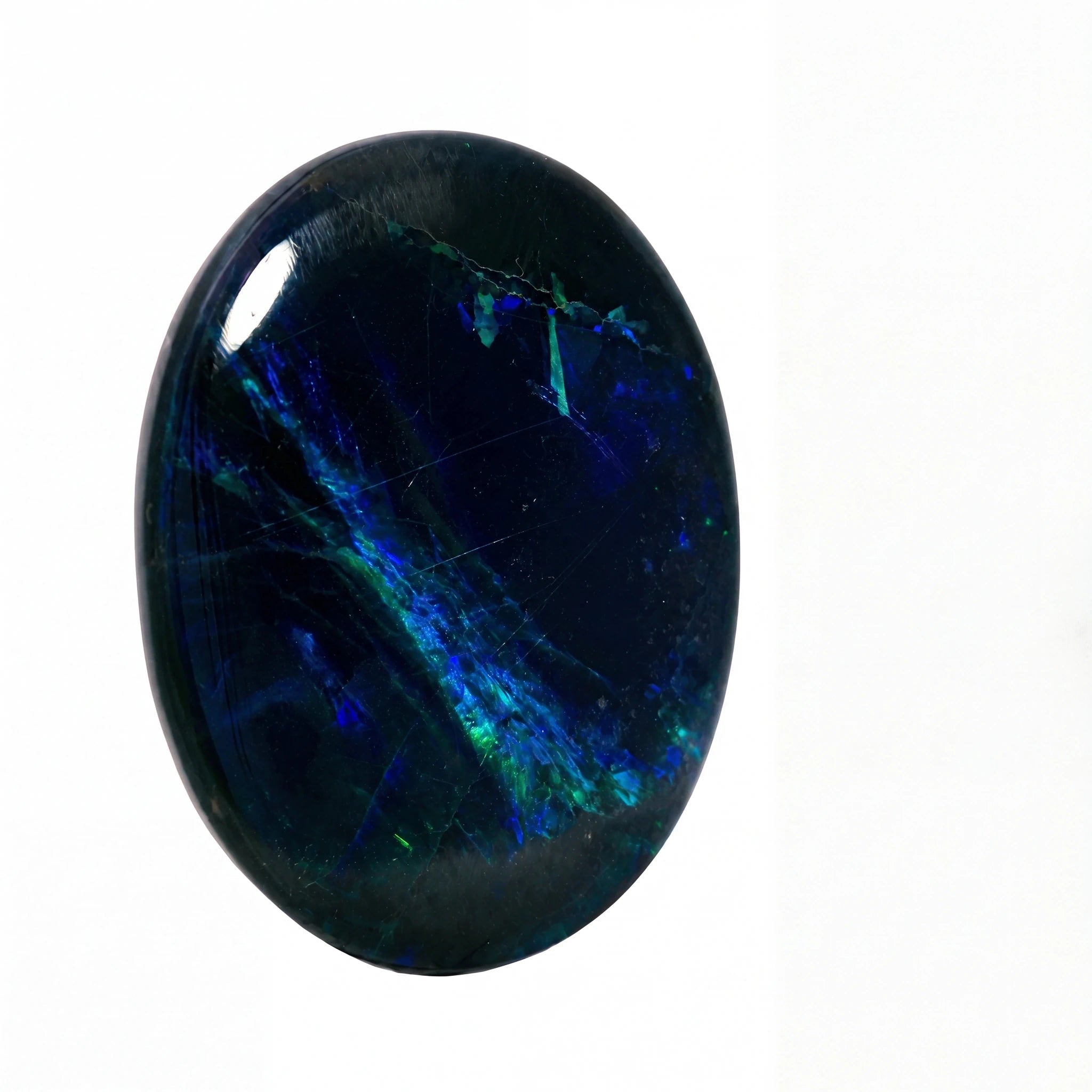 A polished oval cabochon gemstone featuring a deep navy blue base with vibrant blue and green opal-like flashes, set against a plain white background.
