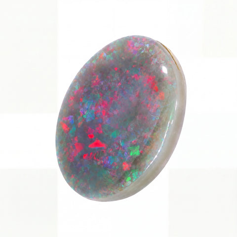A polished oval cabochon gemstone featuring a vibrant play-of-colour opal pattern with red, green, blue, and purple flashes on a grey base, set against a clean white background.