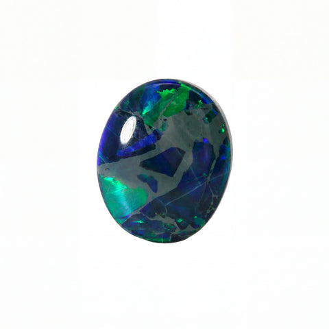 A polished oval cabochon gemstone featuring a vibrant play-of-colour pattern with deep blue, emerald green, and black tones, set against a plain white background.