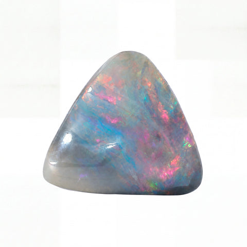 A polished triangular opal stone with a grey base and vibrant iridescent flashes of pink, blue, green, and orange, set against a plain white background.