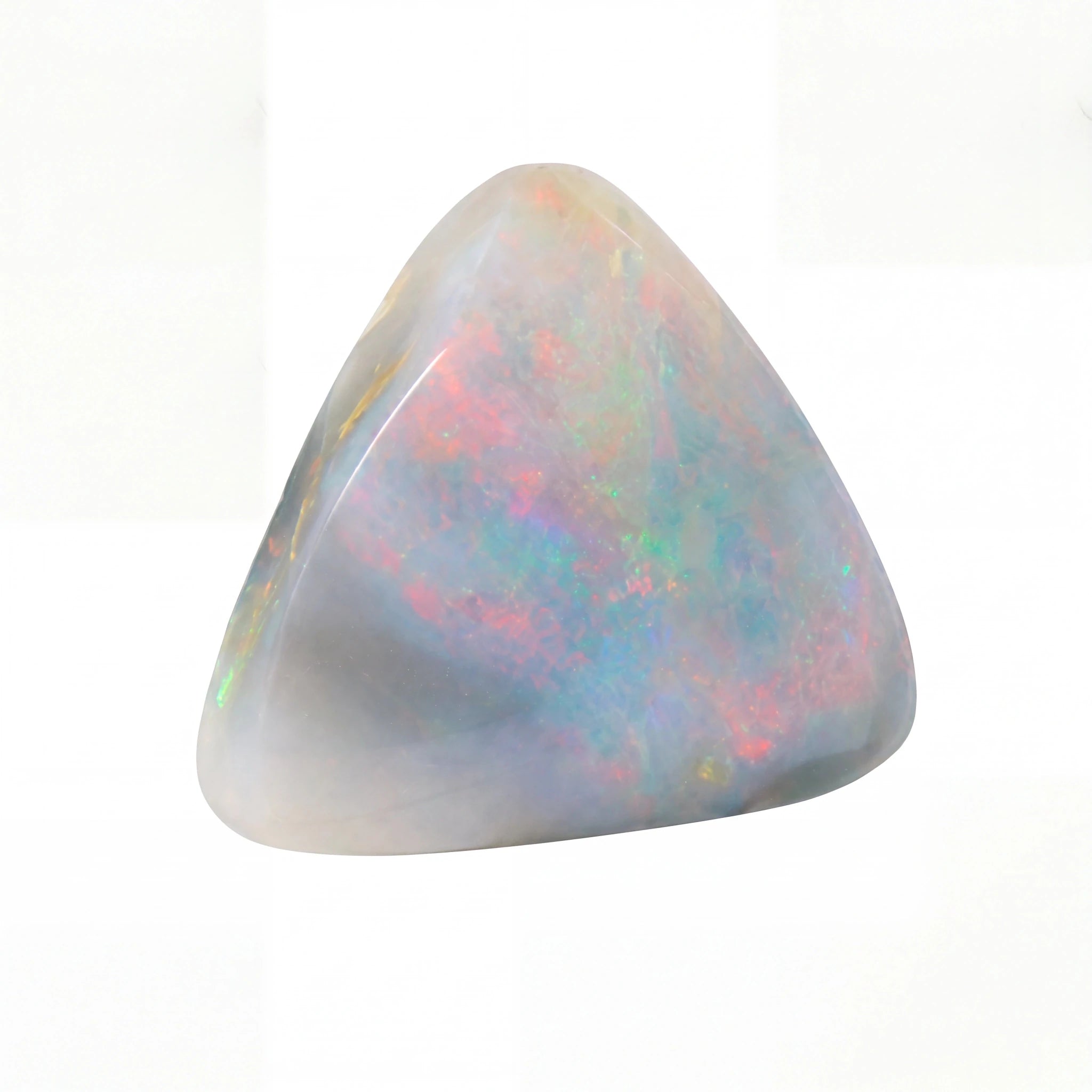 A polished triangular opal stone with iridescent colours of pink, blue, green, and yellow on a white background.