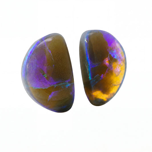 Two polished oval opal gemstones with iridescent purple, blue, green, and orange play-of-colour, displayed side by side on a plain white background.
