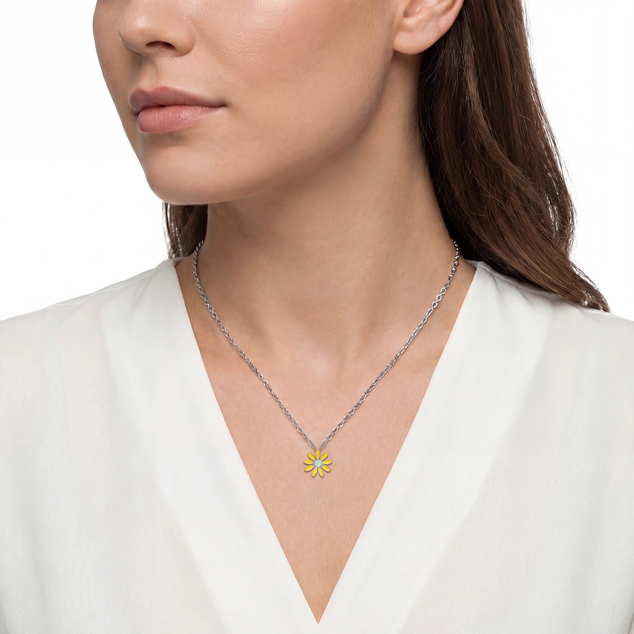 Woman wearing a necklace with a yellow flower pendant on a white background