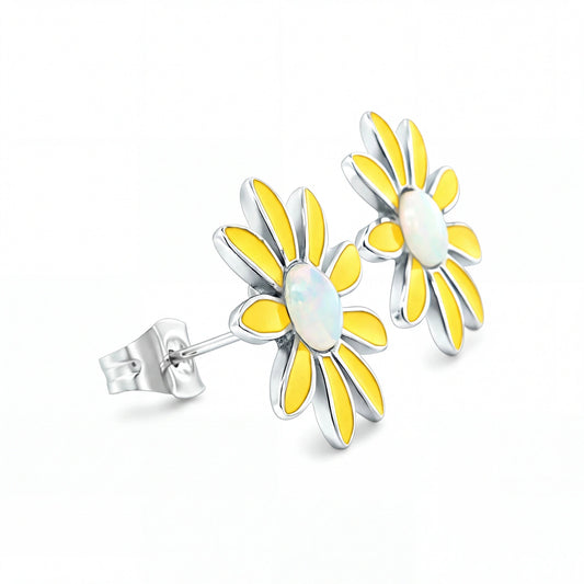 Sunflower-shaped earrings with yellow petals and a white center on a white background