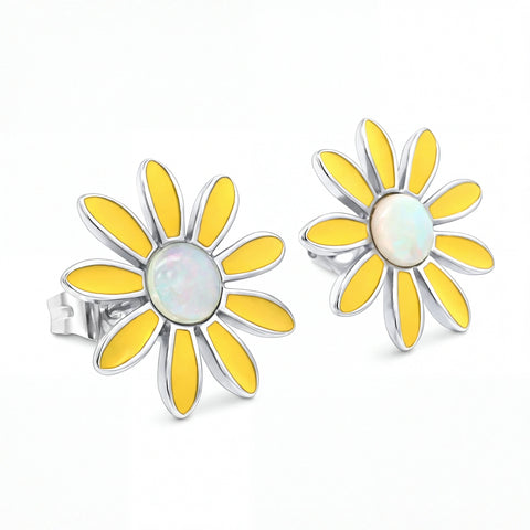 Yellow flower-shaped earrings with a white center on a white background