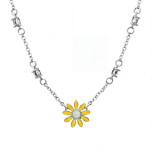 Silver necklace with a yellow flower pendant on a white background