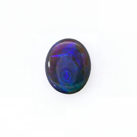 A polished oval cabochon gemstone displaying vibrant iridescent play-of-colour with swirling patterns of blue, purple, and green on a white background.