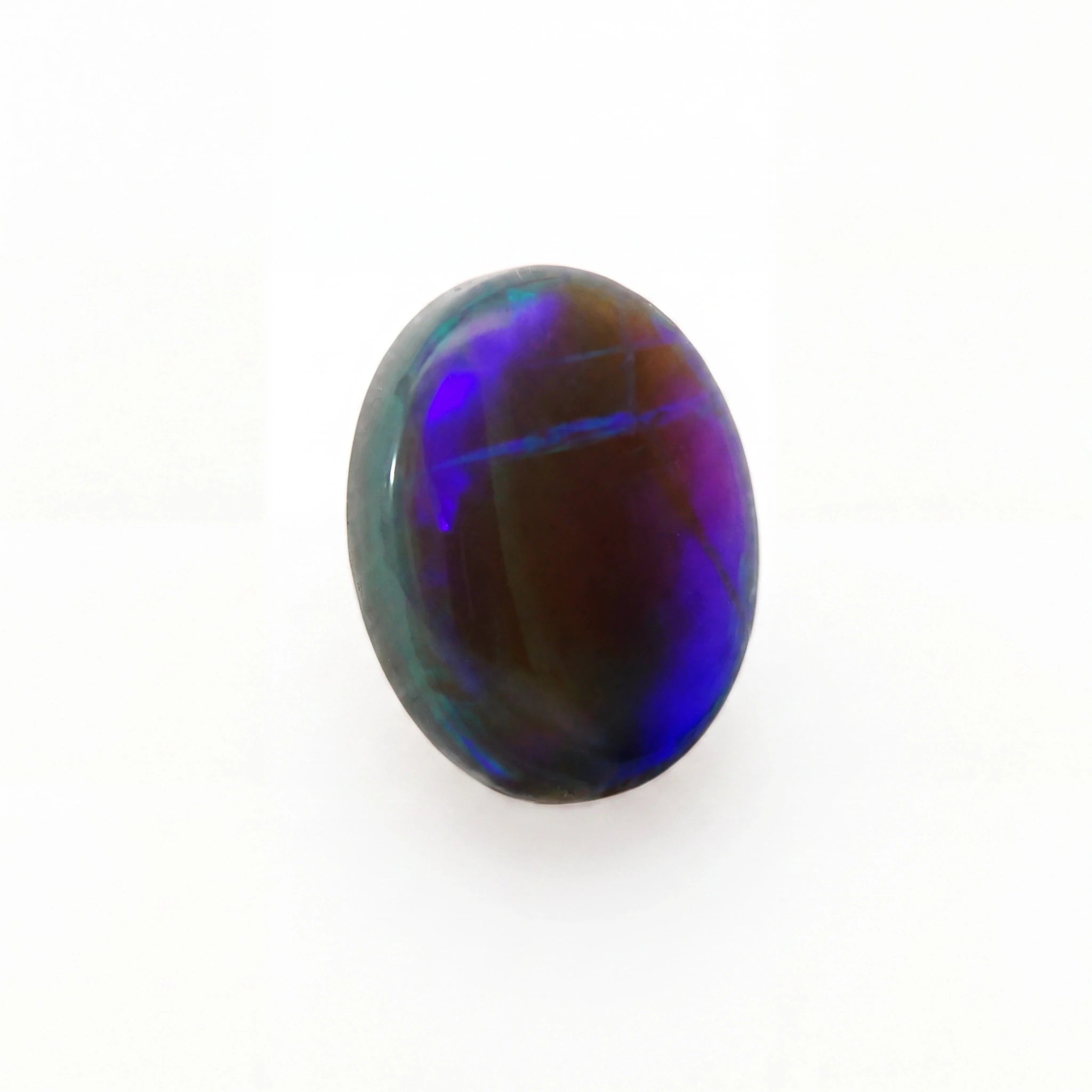 A polished oval cabochon gemstone displaying vibrant iridescent play-of-colour with deep blue, purple, and green hues over a dark brown base, set against a plain white background.