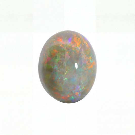A polished oval cabochon gemstone with a play-of-colour pattern featuring green, orange, purple, and blue iridescence on a white background.