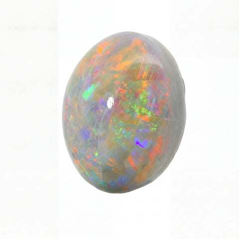 A polished oval cabochon gemstone showing a vibrant play-of-colour opal pattern with orange, green, blue, purple, and red flashes on a white background.