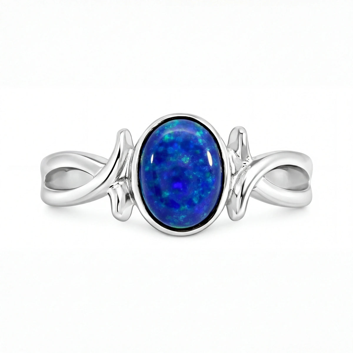 Silver ring with a blue opal stone on a white background