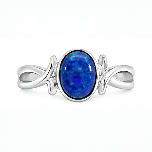 Silver ring with a blue opal stone on a white background