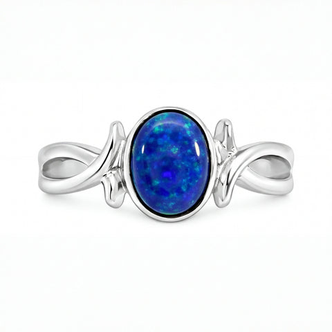 Silver ring with a blue opal stone on a white background