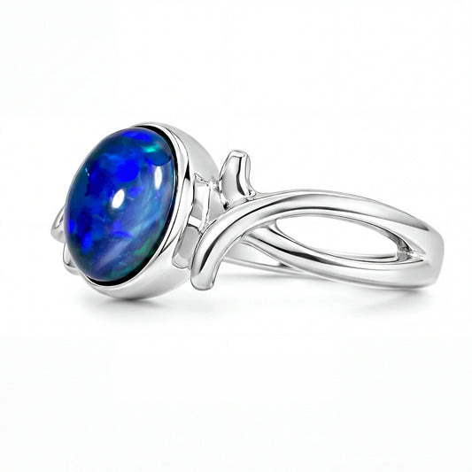 Silver ring with a blue oval gemstone on a white background