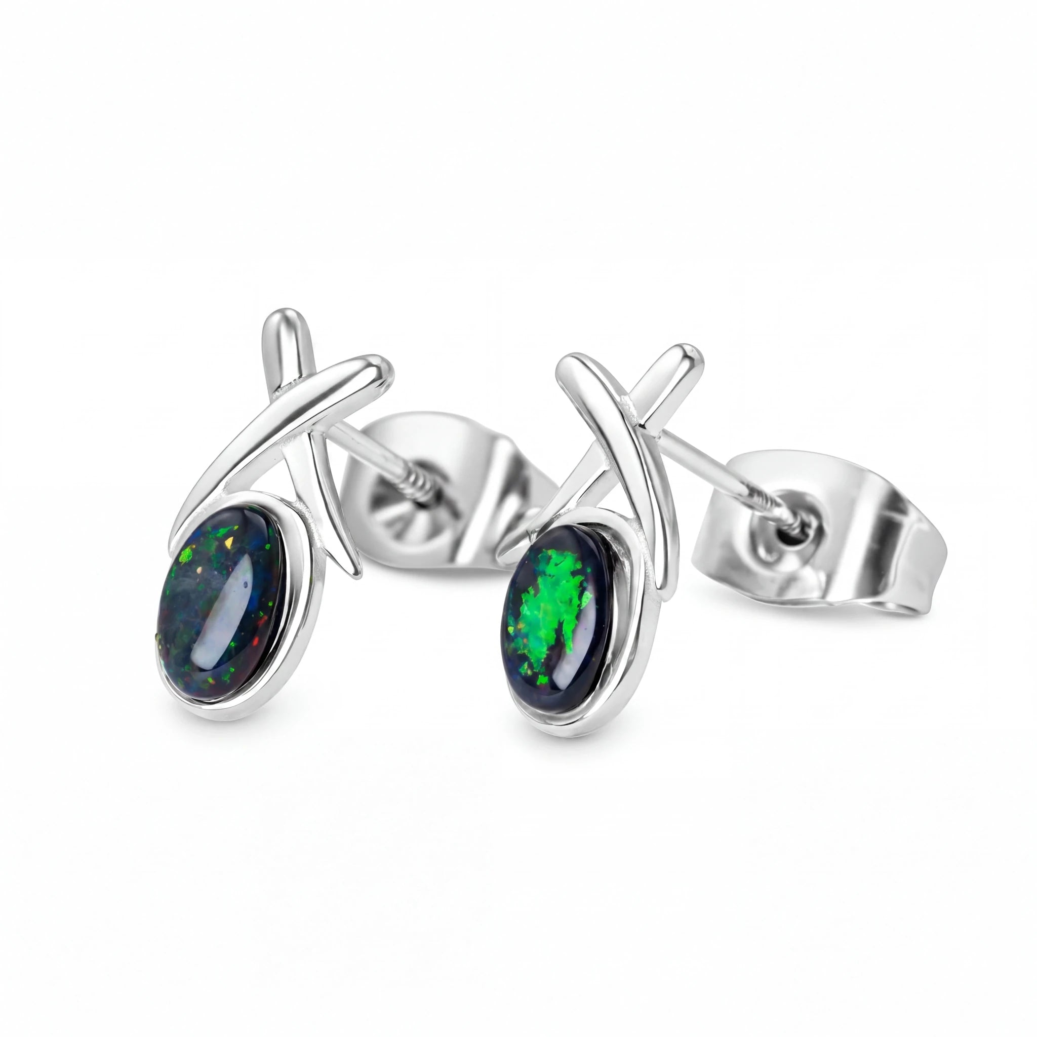 Silver earrings with green and black gemstones on a white background