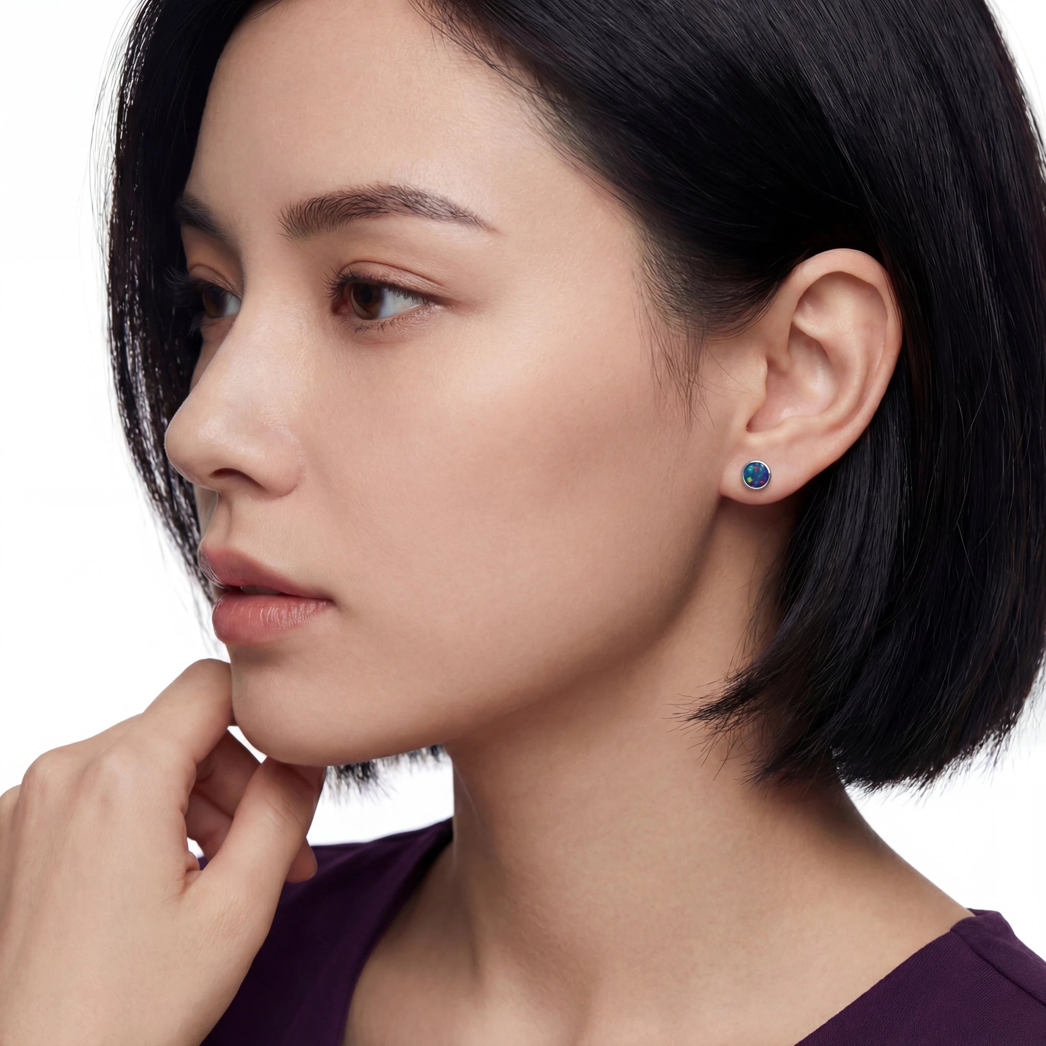 Close-up of a woman wearing earrings with a white background