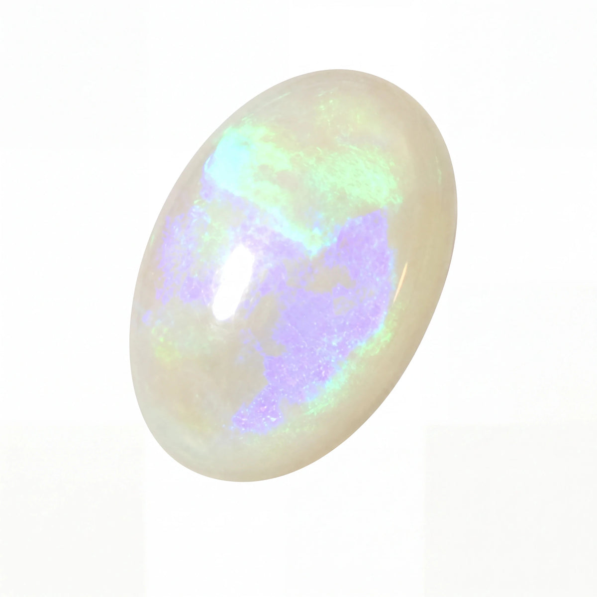 An oval cabochon opal gemstone displaying a play-of-colour with iridescent hues of purple, green, and blue over a creamy white base, set against a plain white background.
