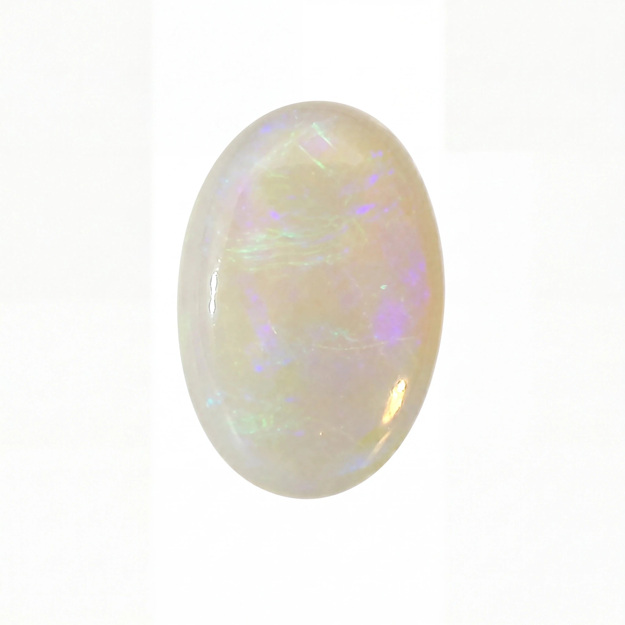 Opal gemstone with multicoloured play of light on a white background