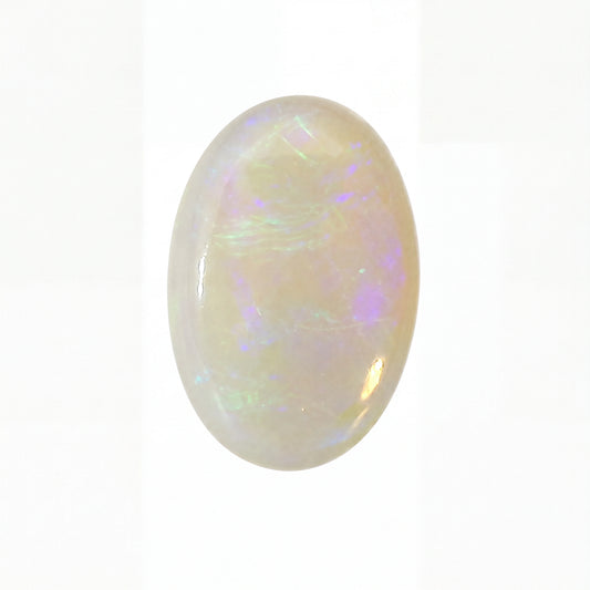 Opal gemstone with multicoloured play of light on a white background
