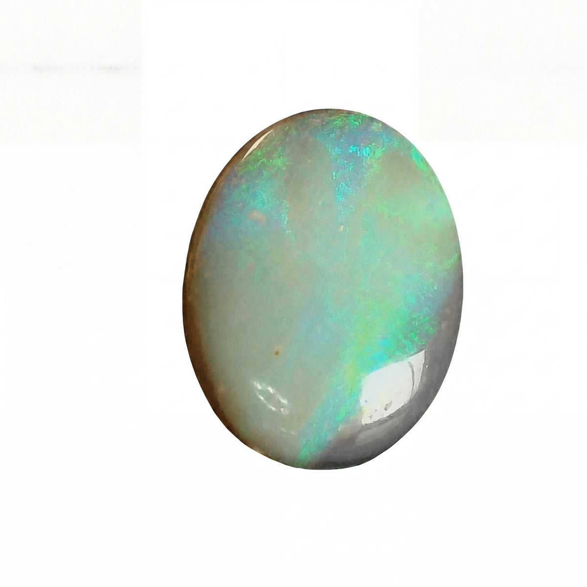Opal stone with multicoloured play of colours on a white background
