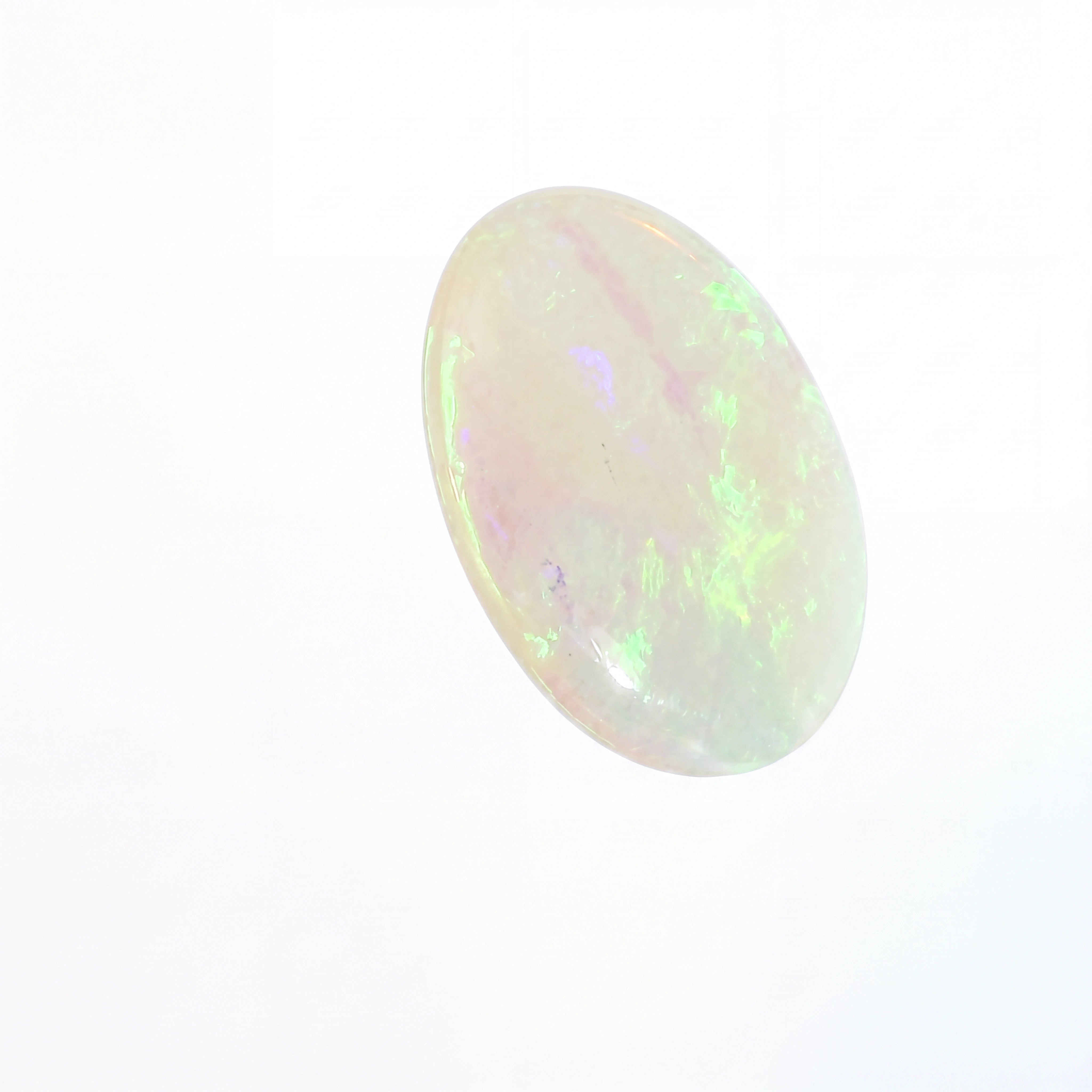 Opal stone with multicoloured play of light on a white background