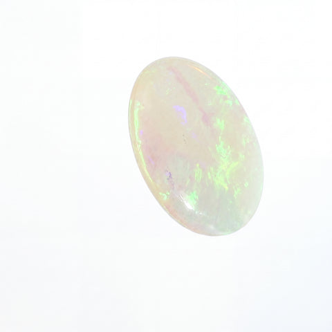 Opal stone with multicoloured play of light on a white background