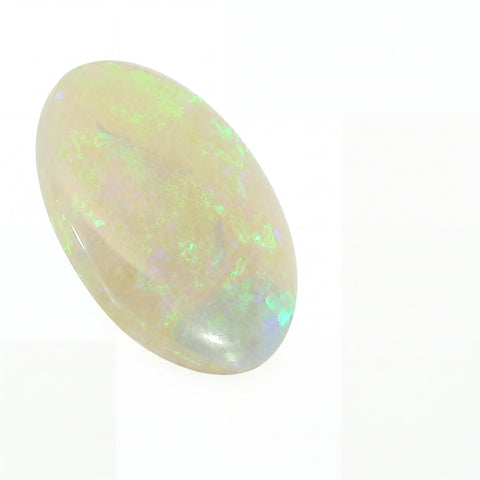 Opal stone with multicoloured play of light on a white background