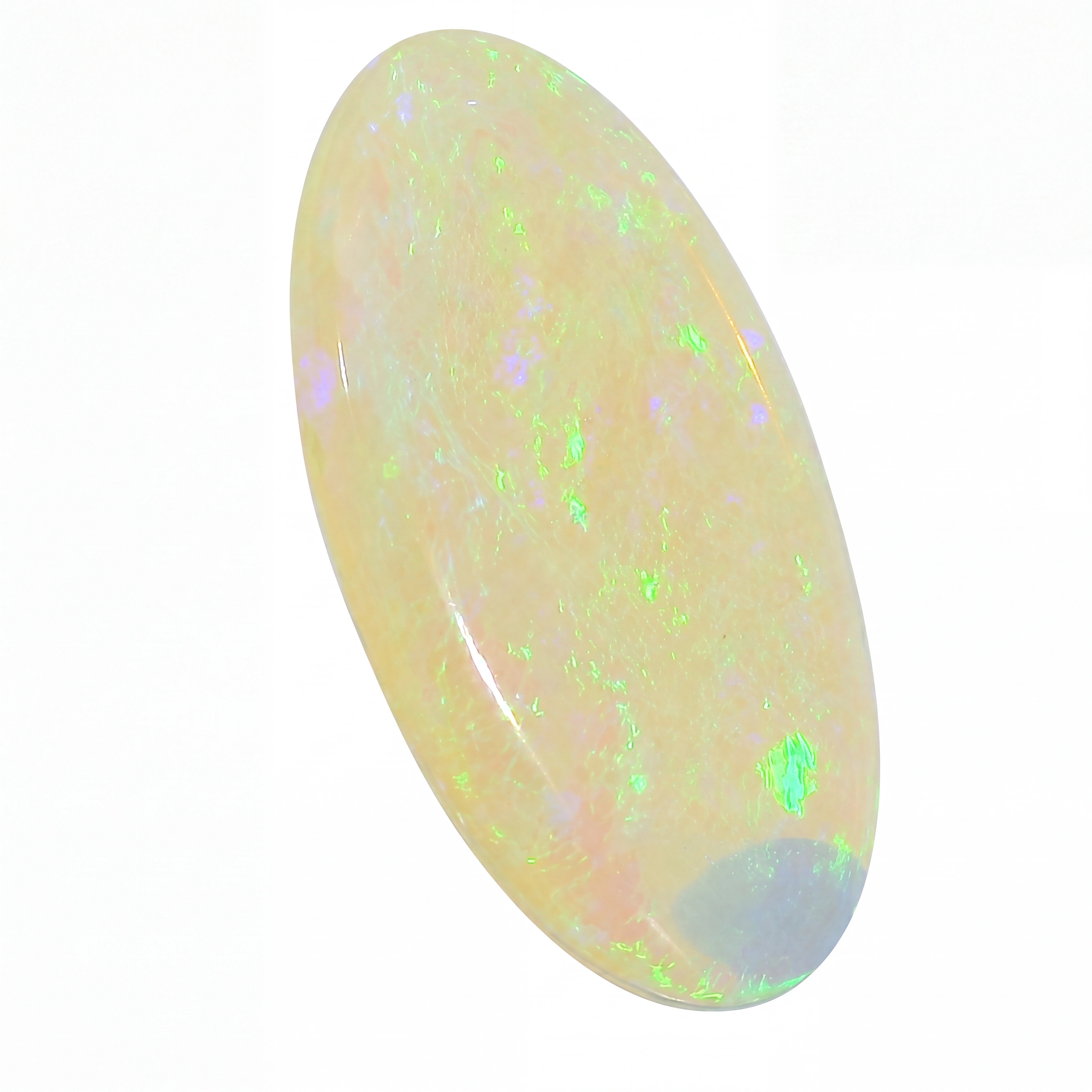 Opal stone with green and purple speckles on a white background