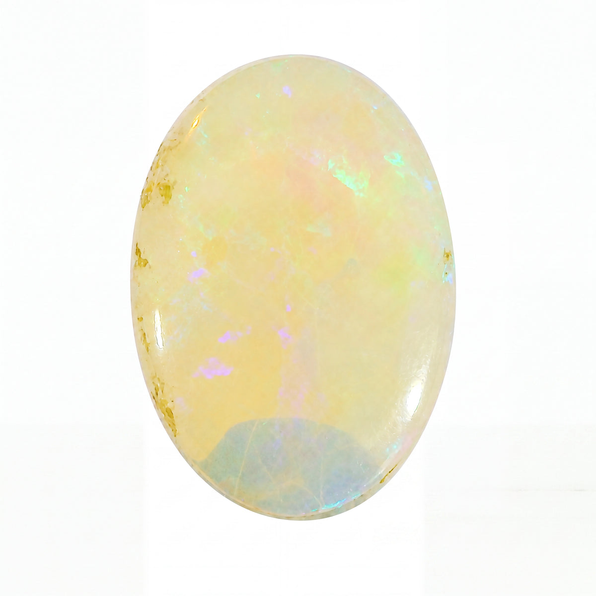 Opal stone with iridescent colours on a white background