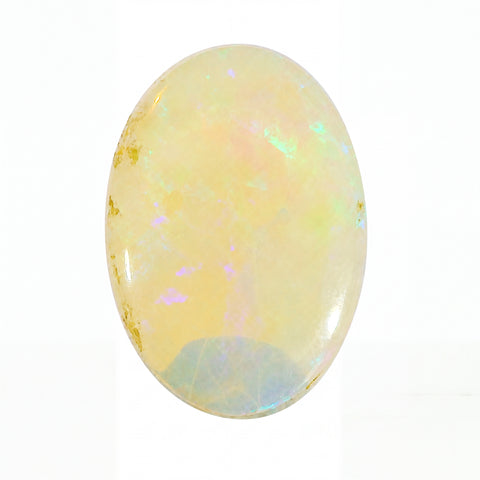 Opal stone with iridescent colours on a white background