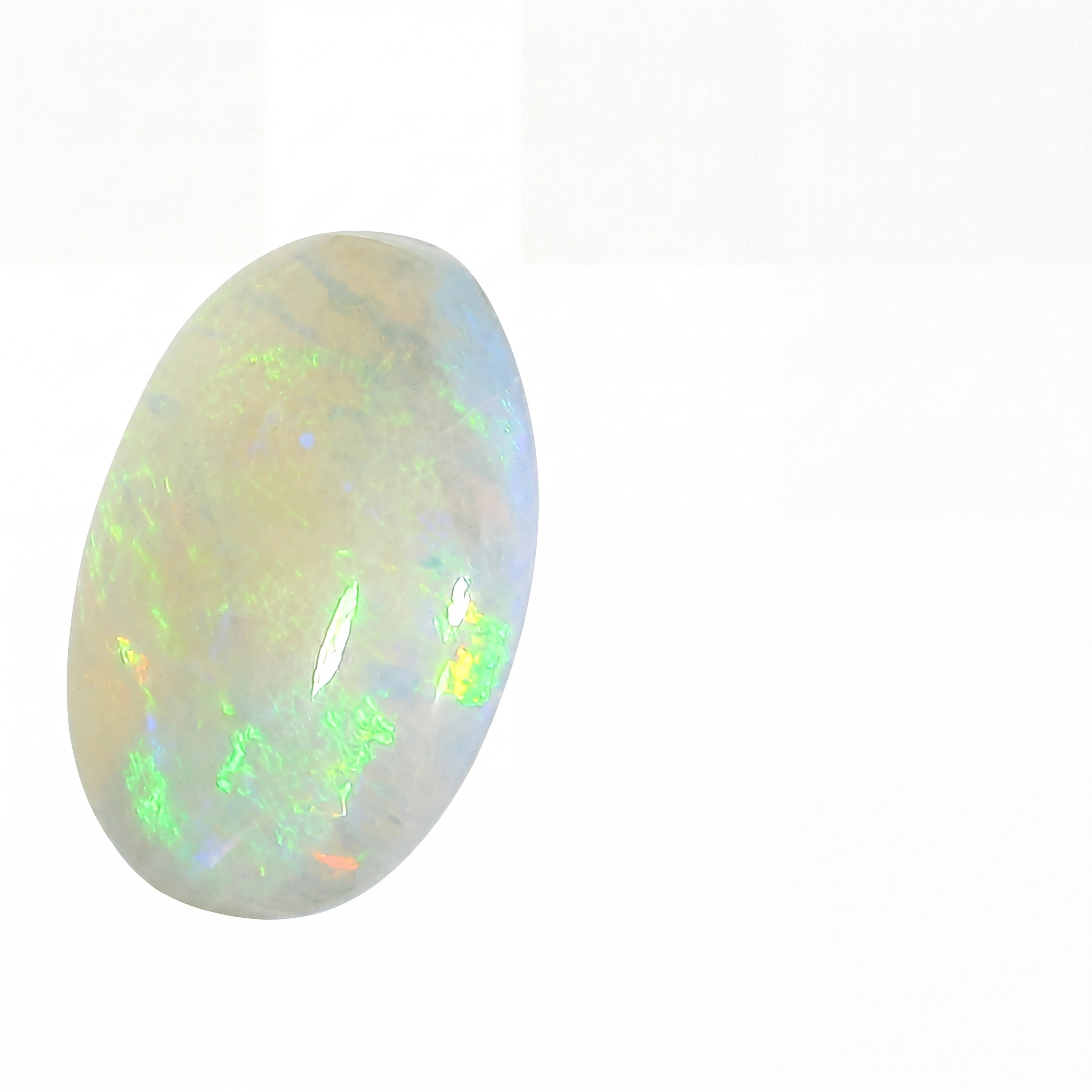 Opal stone with green and white colours on a white background