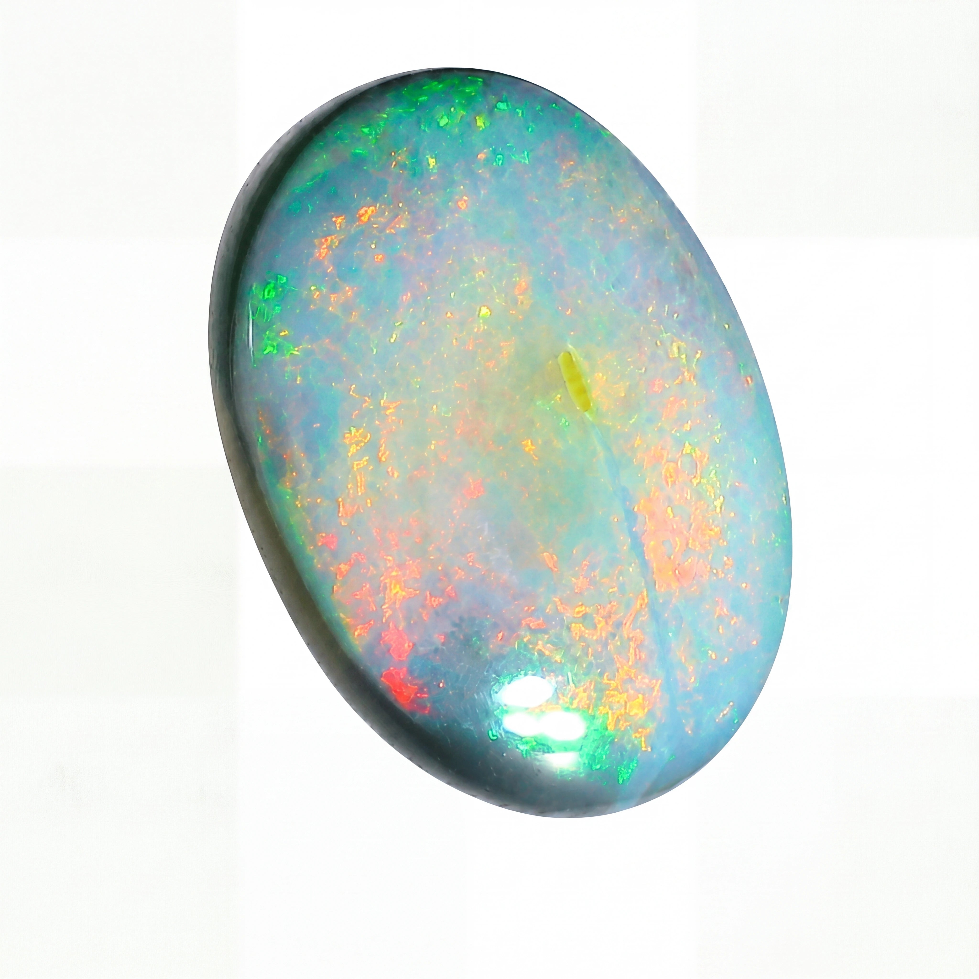 Multicoloured opal stone on a white background