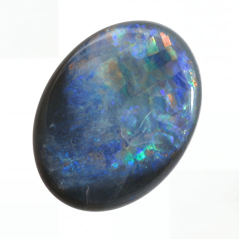 Multicoloured opal stone on a white background