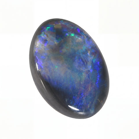 Oval-shaped opal stone with multicoloured play of light on a white background