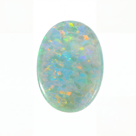 Oval-shaped opal stone with multicolour play of light on a white background