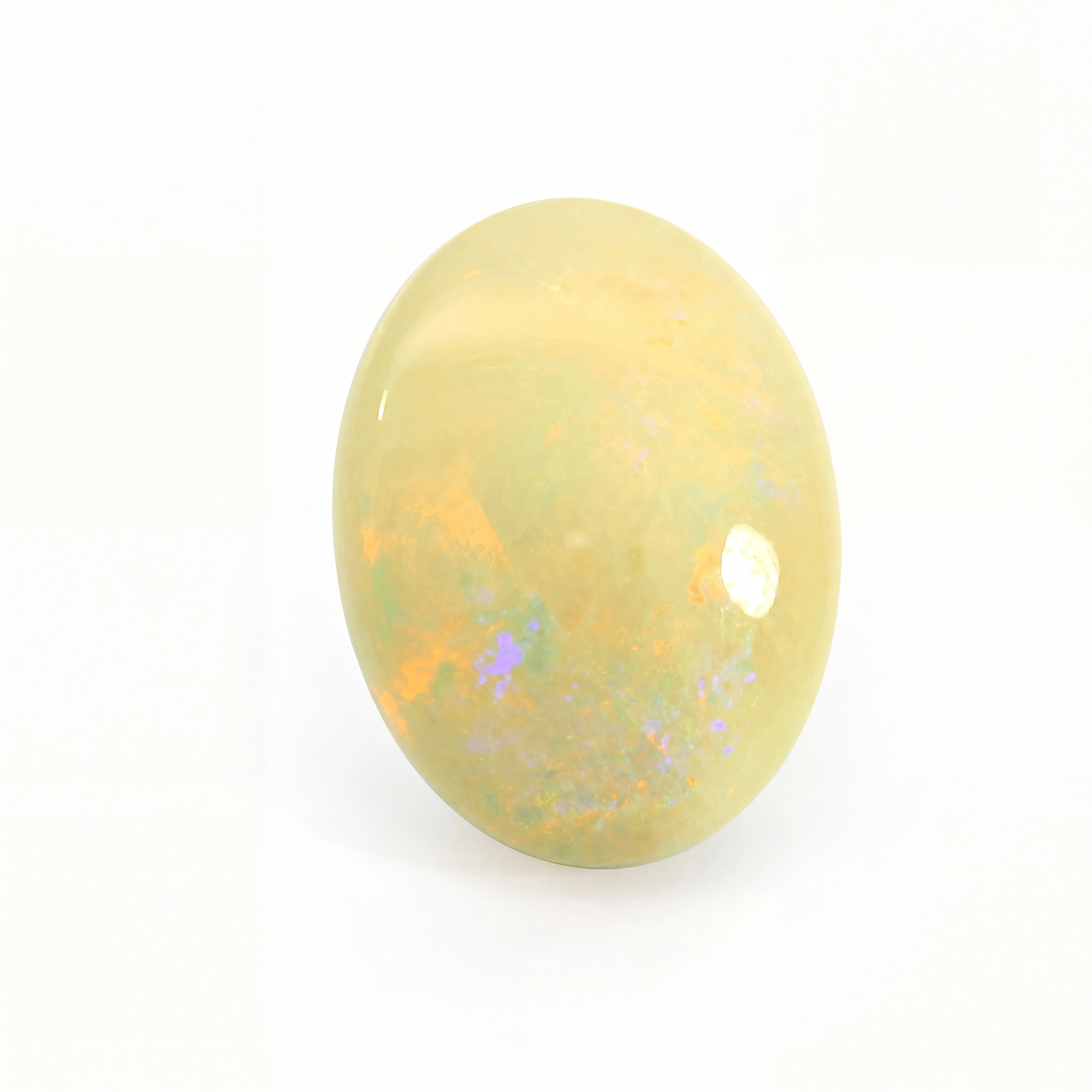 Yellow opal stone with speckled patterns on a white background
