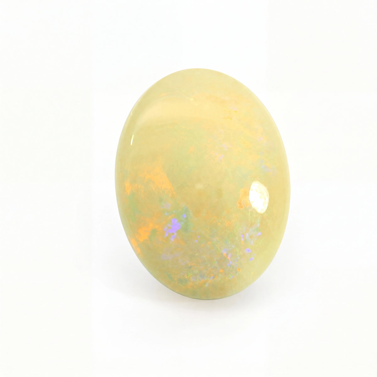 Yellow opal stone with speckled patterns on a white background