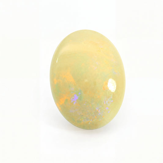 Yellow opal stone with speckled patterns on a white background
