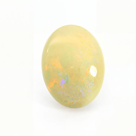 Yellow opal stone with speckled patterns on a white background