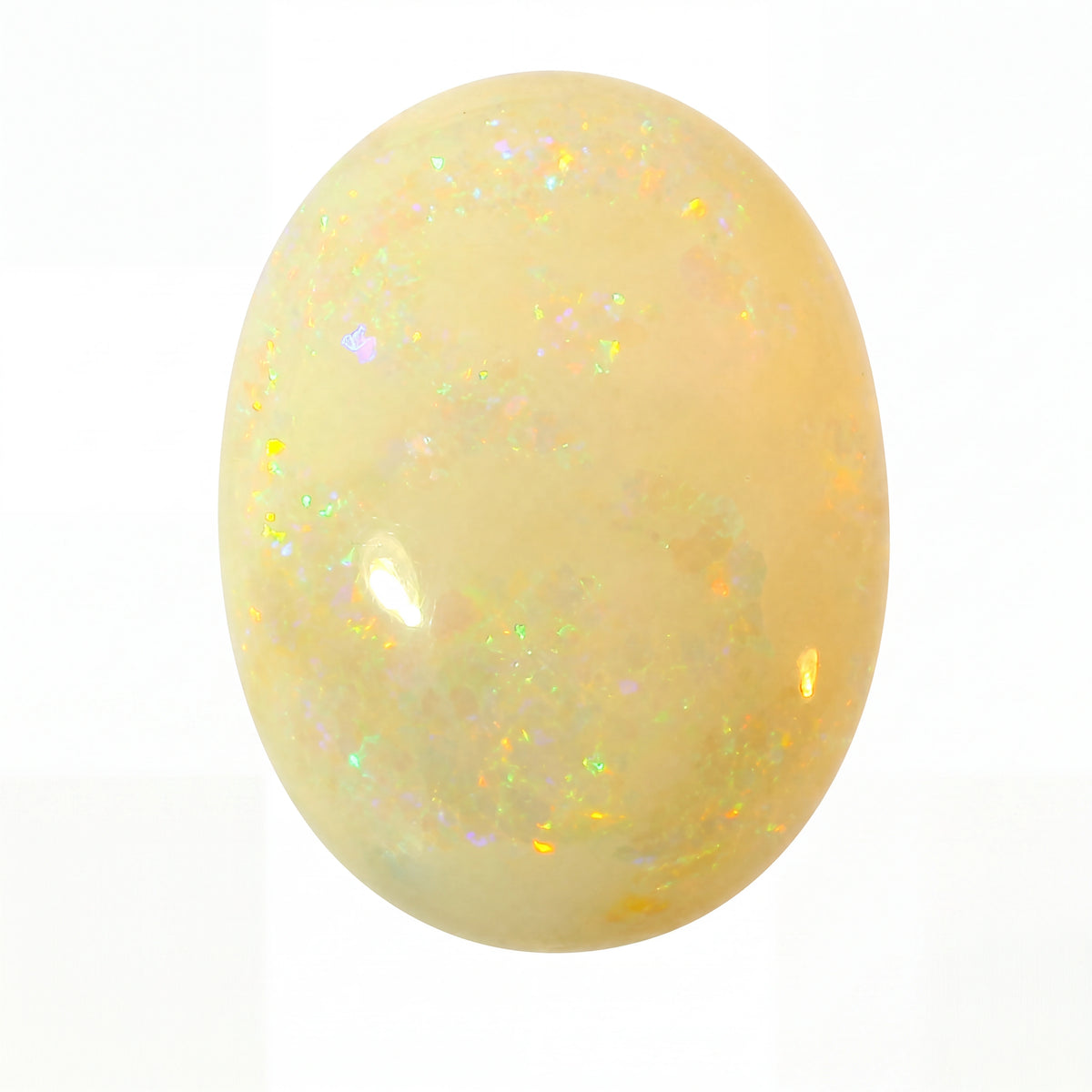 Yellow opal stone with a sparkly surface on a white background