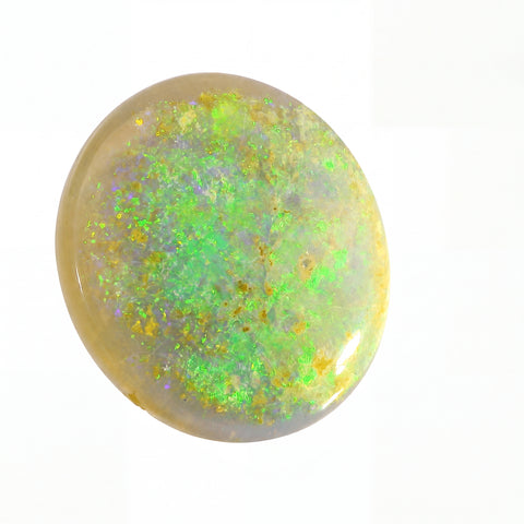 Round opal stone with green and yellow fluorescence on a white background
